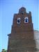 Camino de la Hongallega se ve la torre de la Iglesia de San Cipriano con la cigüeña 
